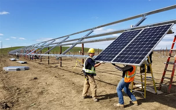 AltaPro Solar team installing a solar panel on a Utility scale project, utility scale solar services